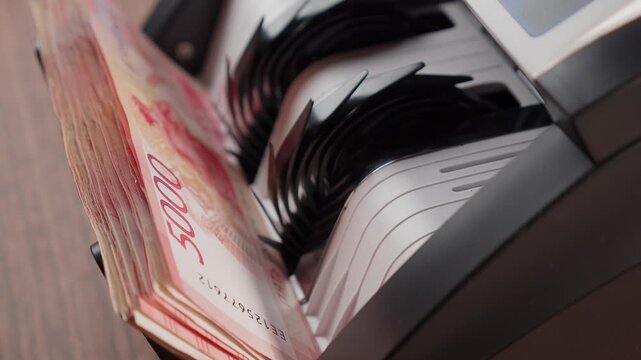 Russian rubles in a money counting machine &mdash; finance and economy concept