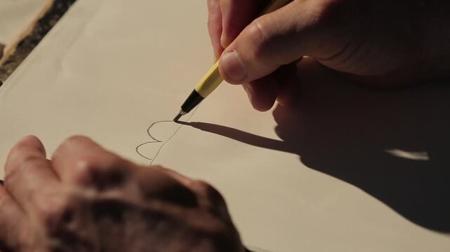 A detailed close-up of a designer's hands sketching decorative elements onto a pattern, transitioning to a full drawing of a traditional costume design.