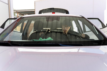 Fototapeta premium Professional car detailer cleaning car windshield