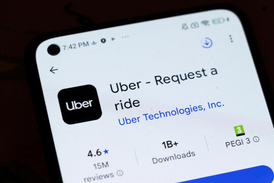Warsaw, Poland - November 6, 2025: Close-up of a smartphone screen displaying the Uber app, featuring the logo, user rating, and download statistics for ride-hailing service.