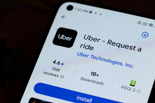 Warsaw, Poland - November 6, 2025: Close-up view of a smartphone screen showcasing the Uber app interface, indicating ratings and download statistics for joining the ride-hailing service.