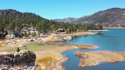 Big Bear Lake, California, USA - Aerial overview of a Wooden Cabin Along a Stream in Big Bear, CA, on July 20, 2024 - Forrest of Trees Covers the Mountains With Pines in the Summer