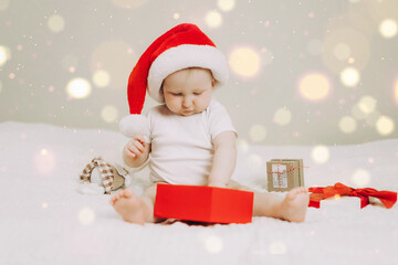 Adorable Baby in Santa Hat with Christmas Gift