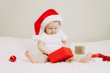 Adorable Baby in Santa Hat with Christmas Gift