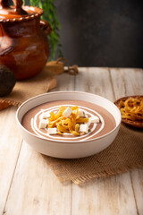 Creamy bean soup. In Mexico known as Crema de Frijoles, nutritious homemade food recipe, commonly accompanied with cheese, cream, avocado and corn tortilla cut into strips and fried.