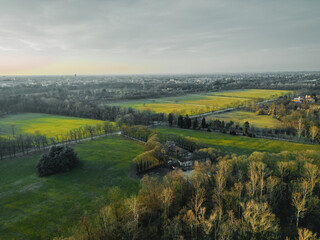 Emerald Vista: An expansive panorama unfolds, showcasing a harmonious blend of nature's beauty &ndash; undulating grasslands, flourishing trees, and the distant outline of a bustling city under a vast.
