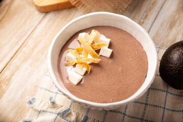 Creamy bean soup. In Mexico known as Crema de Frijoles, nutritious homemade food recipe, commonly accompanied with cheese, cream, avocado and corn tortilla cut into strips and fried.