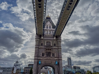 Stunning aerial view of Tower Bridge in London, spanning the River Thames with the city skyline in the background &mdash; blending historic architecture and modern urban beauty. London Bridge
