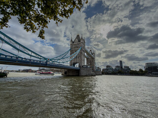 Stunning aerial view of Tower Bridge in London, spanning the River Thames with the city skyline in the background &mdash; blending historic architecture and modern urban beauty. London Bridge