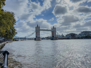 Stunning aerial view of Tower Bridge in London, spanning the River Thames with the city skyline in the background &mdash; blending historic architecture and modern urban beauty. London Bridge