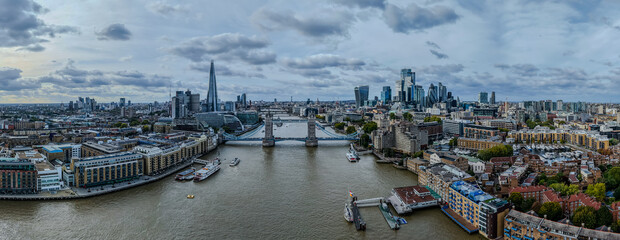 Stunning aerial view of Tower Bridge in London, spanning the River Thames with the city skyline in the background &mdash; blending historic architecture and modern urban beauty. London Bridge
