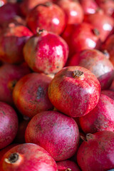 Red ripe pomegranates in a container. bright background, pomegranates close-up
