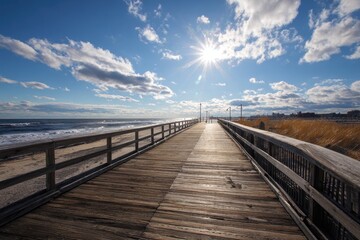 Fototapeta premium Scenic View of Jones Beach Boardwalk Beneath Radiant Sunlight at Jones Beach State Park, Long Island, Showcasing the Coastal Landscape and Wooden Pier