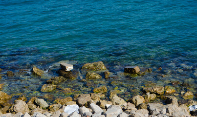 Serene turquoise ocean waters gently lapping rocky shore creating a tranquil coastal scene, perfect for travel inspiration and peaceful relaxation
