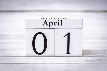Wooden calendar blocks displaying April 01, emphasizing the transition from March to April. Ideal for seasonal promotions, planning, and time management themes.