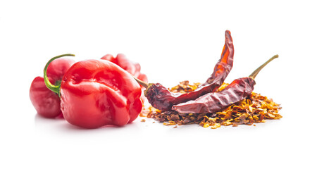 Red chili peppers flakes. Milled spicy peppers and habanero isolated on white background.