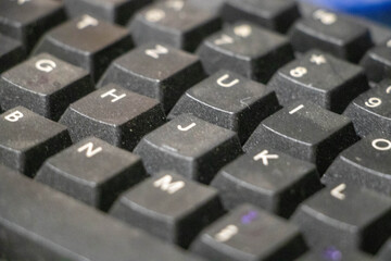 Close up photo of keyboard keys of a used, dusty office keyboard