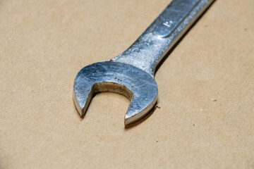 Close up photo of a wrench. Used, scratched, oily