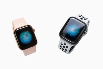Pair of contemporary wrist-worn digital devices showcasing vibrant screen displays against a clean background, embodying advanced wearable technology and personalized connectivity