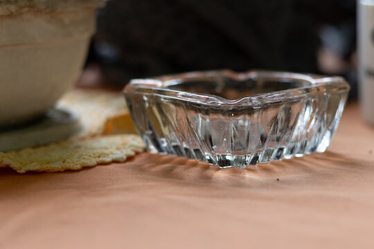Close up of an empty glass ashtray emphasizing the habit and lifestyle during a social coffee break