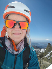 Selfie of a mountaineer at the top of a mountain