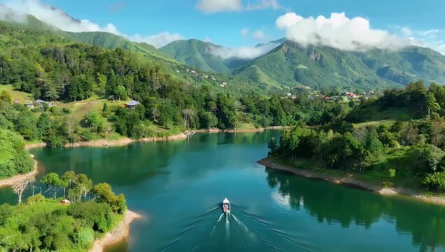 Breathtaking 4K aerial video small boat gliding calmly misty mountain lake Wonosobo surrounded serene hills fog capturing pure tranquility natural beauty