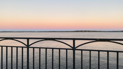 Fototapeta premium Guard Rail Over Lake Monona at Sunset