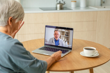 Senior man doctor expert examining older senior woman online. Old woman lady patient and doctor talk on video call have consultation with laptop. Medicine healthcare medical checkup. Online doctor