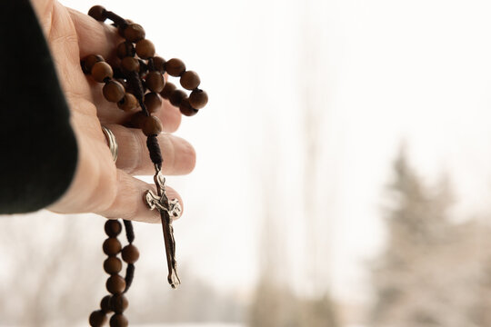 hand holding a rosary