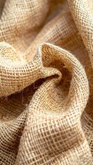 A close-up of coarse, woven natural fiber cloth in a soft, rustic fold