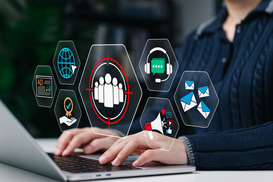 Person using laptop with digital marketing icons representing audience targeting, social media ads, customer support, engagement, SEO, campaigns, email marketing, global online communication strategy - Powered by Adobe