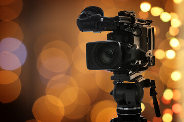Video camera against blurred lights, bokeh effect