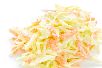 Creamy coleslaw salad with carrot, and cabbage on a white plate.