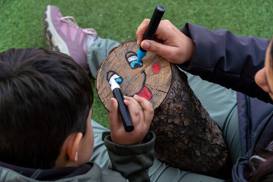 Decorating a Tio de Nadal log in Catalonian tradition