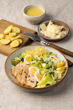 Fresh Caesar salad with chicken and quail eggs
