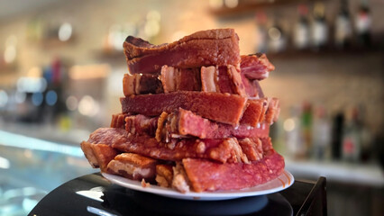 Delicious torreznos crispy pork snack on a plate in a rustic setting. Typical Spanish snack. Traditional tapas in Spain