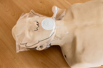 First aid training with CPR manikin and mask