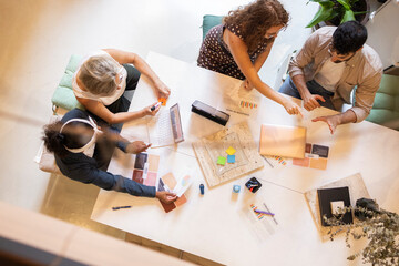 Diverse coworkers discussing creative ideas in office