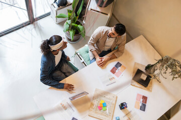 Coworkers collaborating in modern office setting