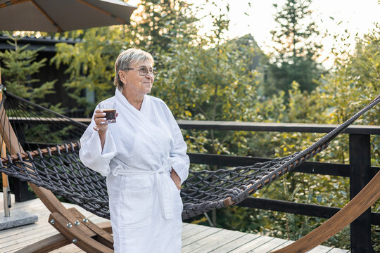 Woman relaxing in a spa setting with beverage in hand