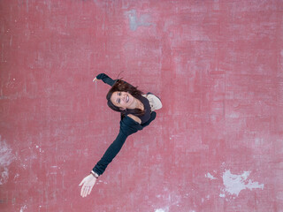 Woman smiling while reaching out on a textured surface