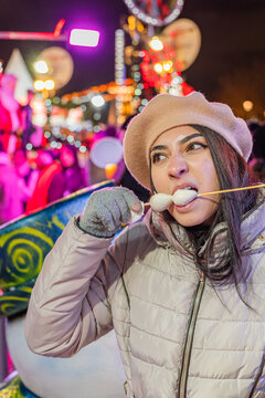 Girl Enjoying Winter Treats in Paris Night Market