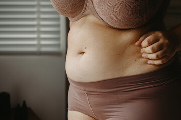 Close-up of woman in lingerie embracing body positivity