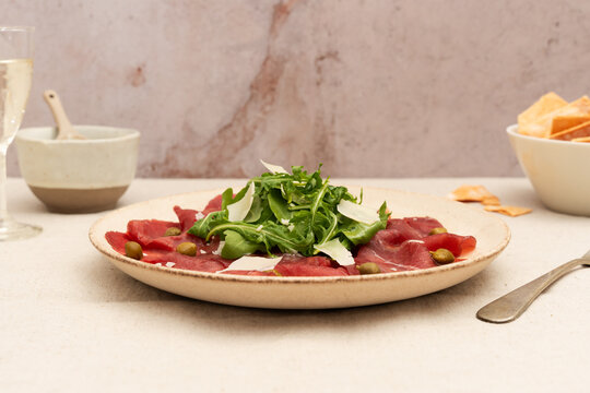 Beef carpaccio with arugula and cheese delight