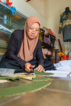 Muslim seamstress crafting fabric design at home