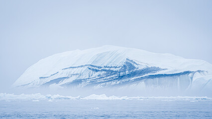 Majestic iceberg floating in Greenland's icy waters