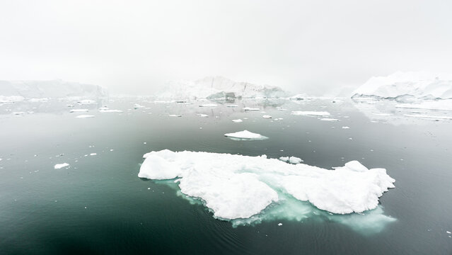 Icebergs drifting in the Arctic waters of Greenland