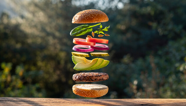 Deconstructed gourmet burger with fresh ingredients like avocado and spinach levitating in the air. - Powered by Adobe