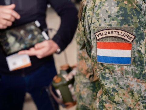 Close-up of Veldartillerie field artillery patch with Netherlands flag on camouflage military uniform sleeve