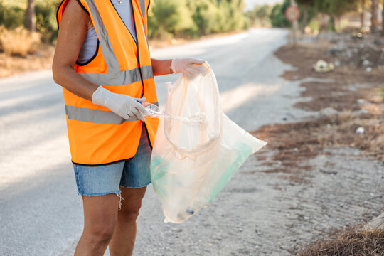 Woman volunteering to clean roadside litter